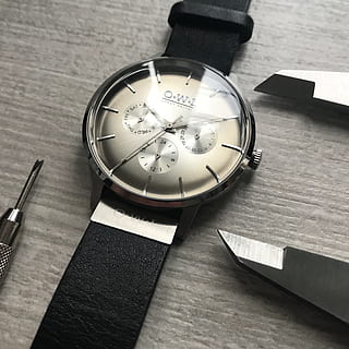 watches, technical, design, time, black, precision, steel, table, indoors, still life, clock, watch, no people, wood - material, high angle view, wristwatch, instrument of time, personal accessory, pen, close-up, book, publication, circle, shape, accuracy, number, minute hand, 2K, CC0, public domain, royalty free