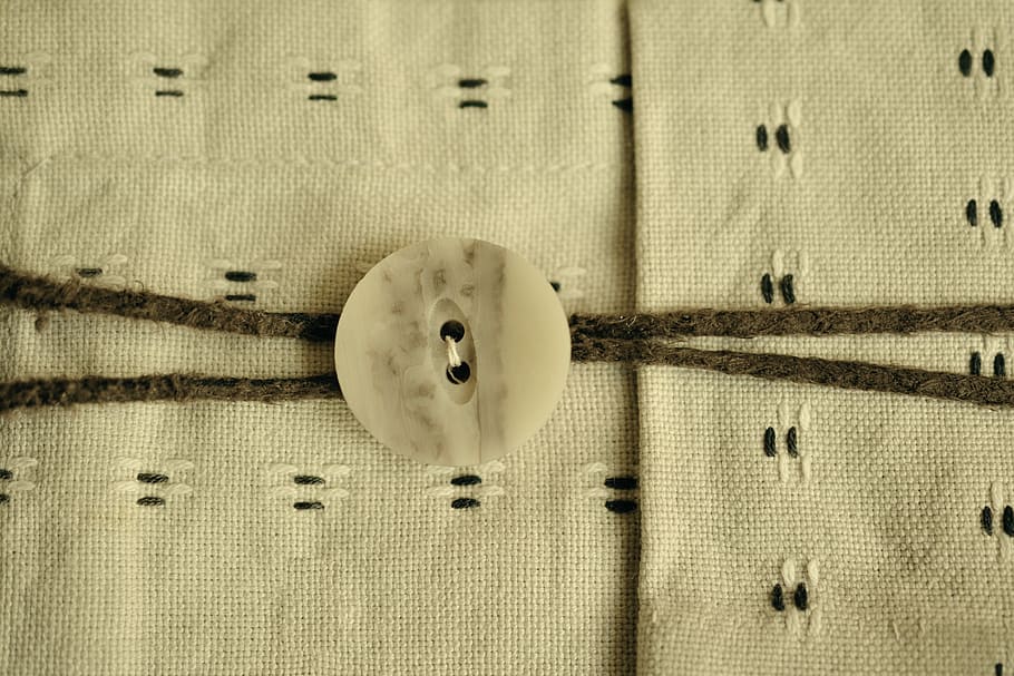 botó de roba beix, botó, teixit, material natural, tela, cosir, costura, tancar, handarbeit, patró, estructura, mà d'obra, reflexió, cap gent, primer pla, a l'interior, dia, tèxtil, textura, marc complet, vell, natura morta, directament a sobre, fons, tecnologia, música, forma geomètrica, taula, centrar-se en primer pla, negocis, roba, cercle, 5K