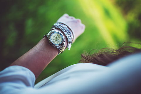 woman, wearing, round chronograph, watch, silver-colored link bracelet, silver, arm, clock, girl, time, hand, past, human body part, wristwatch, selective focus, one person, adult, human hand, holding, women, looking, checking the time, lifestyles, body part, instrument of time, close-up, watching, stopwatch, human limb, 5K, CC0, public domain, royalty free