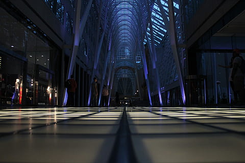 crowd, people, inside, triangular, building, interior, standing, mall, light, building interior, shopping, dark, gallery, solitude, alone, modern, symmetrical, darkness, canada, new york, city, architecture, built structure, indoors, illuminated, incidental people, lighting equipment, ceiling, reflection, the way forward, direction, shadow, flooring, sunlight, pattern, surface level, corridor, glass - material, architectural column, luxury, 5K, CC0, public domain, royalty free