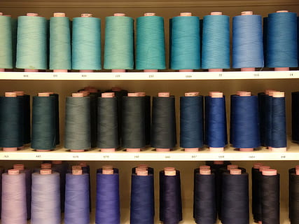sewing thread, thread, thread spool, blue, turquoise, petrol, spool, choice, variation, large group of objects, in a row, no people, indoors, side by side, full frame, shelf, arrangement, close-up, multi colored, order, backgrounds, still life, industry, communication, retail, 2K, CC0, public domain, royalty free