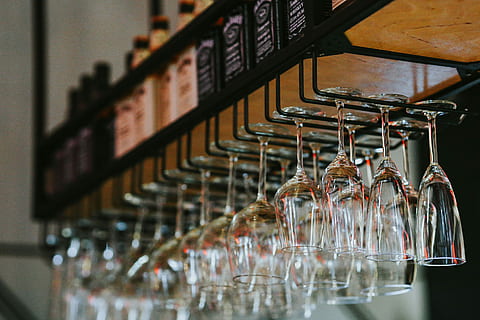 pub, Interior, table, coffee, bar, glasses, drinks, alcohol, liquor, shelf, indoors, no people, large group of objects, drink, in a row, arrangement, focus on foreground, bar - drink establishment, business, rack, order, food and drink, glass - material, selective focus, abundance, food and drink industry, bar counter, metal, restaurant, collection, glass, 5K