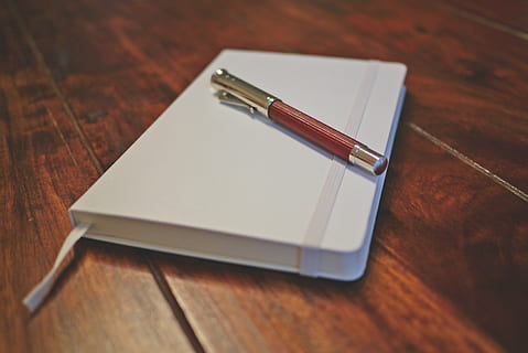 pen, white, planner, notebook, write, diary, wooden, table, wood - material, indoors, no people, close-up, note pad, day, copy space, business, paper, office, still life, blank, focus on foreground, high angle view, furniture, two objects, selective focus, office supply, wood grain, fountain pen, message, silver colored, 4K, CC0, public domain, royalty free