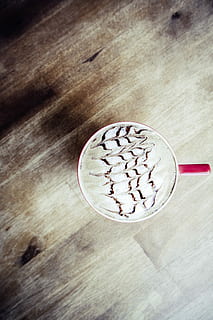 Hot chocolate, cafe, caffe latte, caffelatte, cappuccino, chocolate, coffee, coffee bar, cup, drink, latte, latte art, latteart, milk, red, sweet, table, wood, wood - Material, food, brown, close-up, no People, frothy drink, food and drink, coffee - drink, indoors, still life, refreshment, freshness, high angle view, directly above, coffee cup, mug, kitchen utensil, glass, froth, 4K, CC0, public domain, royalty free