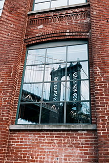 gray windowpane, building, window, glass, reflection, bridge, brick, wall, red, architecture, structure, earth, nyc, sharp, travel, new york, building exterior, brick wall, built structure, text, day, no people, wall - building feature, western script, glass - material, low angle view, communication, outdoors, city, graffiti, window frame, 2K, CC0, public domain, royalty free