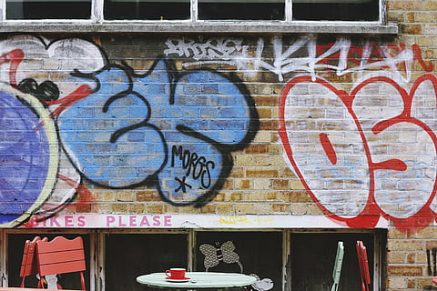 graffiti wall, wall, bricks, paint, vandal, art, letters, table, chairs, cup, empty, graffiti, text, street art, architecture, building exterior, built structure, day, communication, outdoors, store, art and craft, creativity, wall - building feature, no people, western script, human representation, representation, multi colored, craft, mural, 5K, CC0, public domain, royalty free