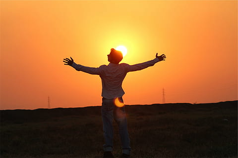 man, white, dress shirt, standing, green, grass field, sunset, silhouette, dusk, sky, guy, people, human arm, limb, arms raised, arms outstretched, human body part, orange color, human limb, body part, one person, sun, back lit, nature, sunlight, men, land, hand, freedom, outdoors, lens flare, hand raised, 1080P, CC0, public domain, royalty free