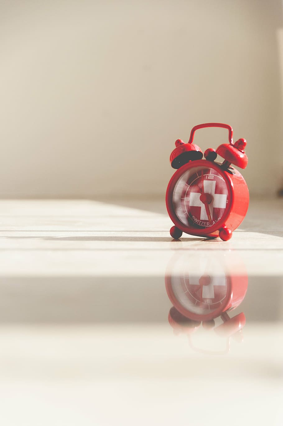 alarm clock, clock, reflection, time, close-up, no people, indoors, red, single object, table, toy, deadline, still life, focus on foreground, clock face, bell, copy space, selective focus, accuracy, retro styled, man made, 4K