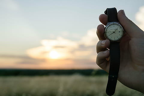 person, holding, round silver-colored analog, watch, outdoors, selective, focus, round, analog, time, hands, human hand, human body part, sunset, sky, one person, one man only, hand, nature, clock, wristwatch, cloud - sky, focus on foreground, body part, finger, human finger, environment, land, human limb, 5K