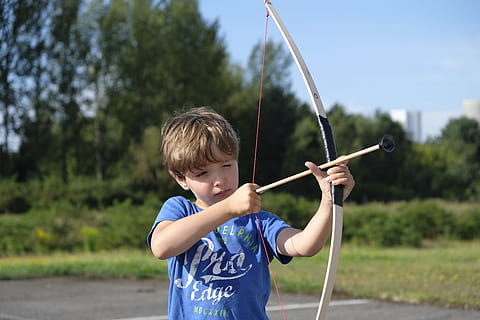 boy, holding, beige, bow, arrow toy, child, arch, archery, shoot, objectives, arrow, play, fun, boys, men, childhood, males, one person, waist up, day, leisure activity, nature, tree, plant, standing, sport, casual clothing, real people, front view, outdoors, arrow - bow and arrow, innocence, 5K, CC0, public domain, royalty free