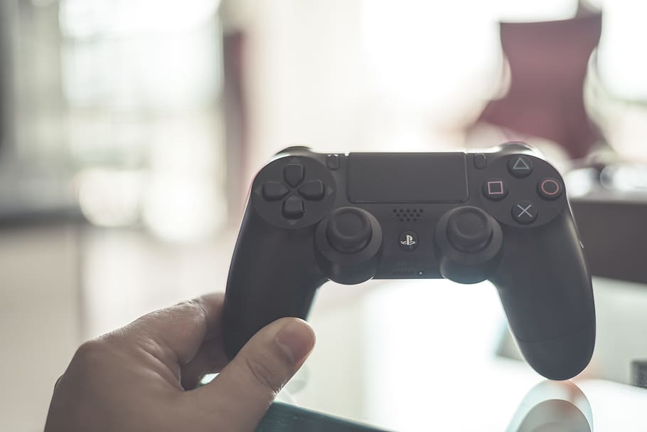 person, holding, black, playstation dualshock 4, controller, playstation, hand, game, console, video, joystick, entertainment, gamepad, leisure, gaming, fun, toy, white, button, station, videogame, equipment, peripheral, wireless, electronic, keypad, activity, remote, human hand, human body part, one person, focus on foreground, close-up, technology, indoors, body part, personal perspective, communication, day, adult, human finger, finger, connection, wireless technology, 5K