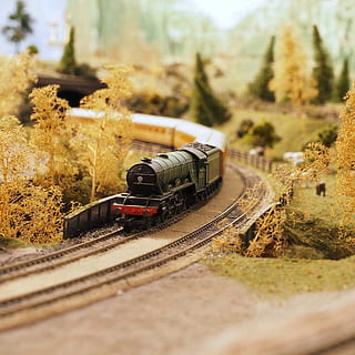 black, red, miniature, train, surrounded, artificial, trees, grass, blur, focus, historic, nostalgia, old, rail, railroad, rails, railway, railway track, railways, tracks, train station, train tracks, transport, vintage, transportation, mode of transportation, rail transportation, selective focus, railroad track, train - vehicle, track, public transportation, day, plant, tree, nature, no people, land vehicle, architecture, on the move, travel, outdoors, tilt-shift, shunting yard, 2K, CC0, public domain, royalty free