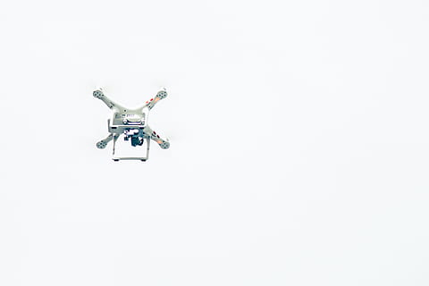 white quadcopter, white, drone, sky, grey, quadcopter, screenshot, flying, air Vehicle, helicopter, copter, airplane, air, propeller, transportation, technology, remote Controlled Toy, surveillance, media equipment, white background, no people, studio shot, big brother - orwellian concept, copy space, futuristic, camera - photographic equipment, mid-air, indoors, security, photography themes, control, wireless technology, security camera, connection, single object, 5K, CC0, public domain, royalty free