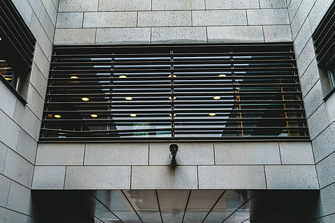 low, angle photo, building, architecture, infrastructure, structure, establishment, windows, cctv, camera, built structure, walking, indoors, one person, modern, building exterior, day, city, adult, real people, lifestyles, pattern, men, rear view, staircase, outdoors, window, standing, low angle view, 5K