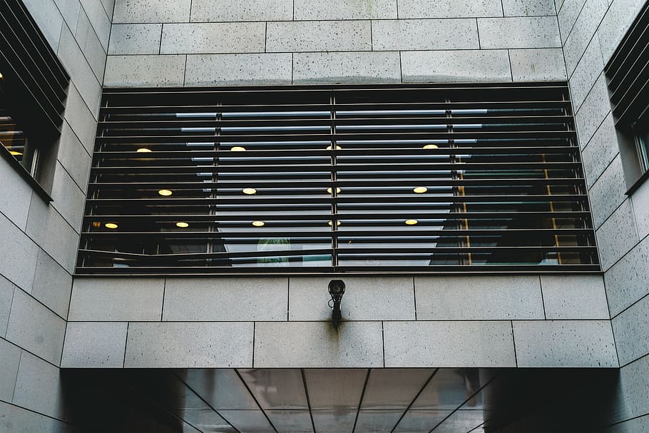 low, angle photo, building, architecture, infrastructure, structure, establishment, windows, cctv, camera, built structure, walking, indoors, one person, modern, building exterior, day, city, adult, real people, lifestyles, pattern, men, rear view, staircase, outdoors, window, standing, low angle view, 5K