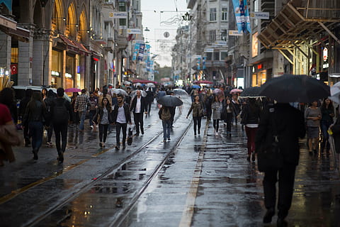 people on street, crowd, people, walking, street, city, men, women, rainy, umbrella, wet, architecture, buildings, structure, city life, city street, large group of people, pedestrian, adult, group of people, rain, built structure, building exterior, transportation, rainy season, real people, protection, outdoors, waiting, 5K