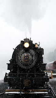 black, train, railway, daytime, running, rail, winter, engine, snow, snowing, steam train, sky, architecture, building exterior, built structure, cold temperature, nature, cloud - sky, no people, history, day, motion, building, outdoors, transportation, travel destinations, the past, 5K, CC0, public domain, royalty free