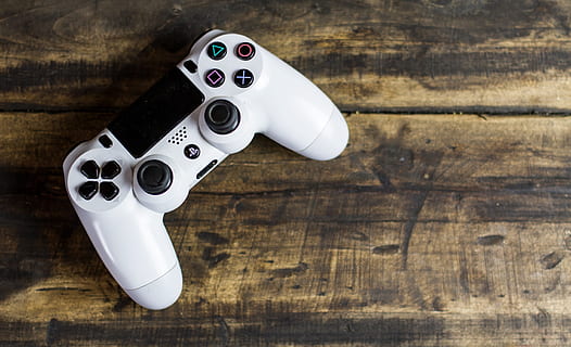 top-view angle photo, ps4, ps 4 dualshock controller, beige, surface, Controller, Games, Video, Buttons, gaming, playstation, technology, entertainment, play, leisure, fun, console, electronic, control, joystick, pad, gamepad, white, recreation, action, player, screen, television, hand, tv, equipment, remote, accessory, joypad, hardware, wood - Material, gun, single Object, handgun, no people, close-up, day, indoors, table, high angle view, still life, directly above, arts culture and entertainment, white color, flooring, communication, silver colored, work tool, studio shot, metal, 4K, CC0, public domain, royalty free