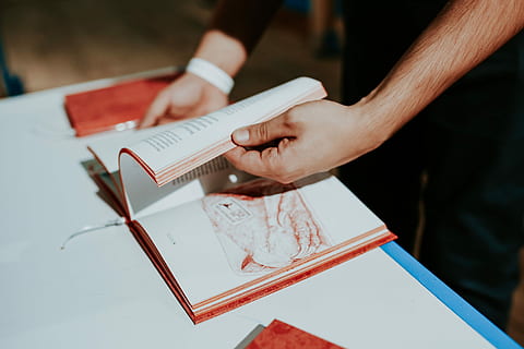 red, book, white, table, Red book, reading, literature, cookbook, people, working, men, occupation, human Hand, adult, creativity, construction Industry, writing, human body part, mail, hand, real people, indoors, holding, high angle view, women, two people, midsection, paper, close-up, place of worship, unrecognizable person, publication, finger, 4K