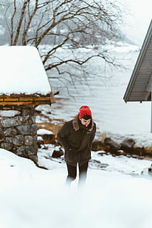 home, marró, jaqueta amb caputxa amb tapa de pell, portar, vermell, Teixir, tapa, caminar, terreny nevat, durant el dia, pell, retallada, encaputxats, jaqueta, gorro de punt, neu, terreny, hivern, a l'aire lliure, gent, fred - temperatura, naturalesa, temporada, una persona, dones, ètnia caucàsica, nen, temperatura de fred, roba calenta, barret de punt, roba, persones reals, barret, arbre, dia, arquitectura, estils de vida, activitat d'oci, estructura construïda, Color blanc, camp, de peu, clima extrem, 4K, CC0, domini públic, lliure de regalies