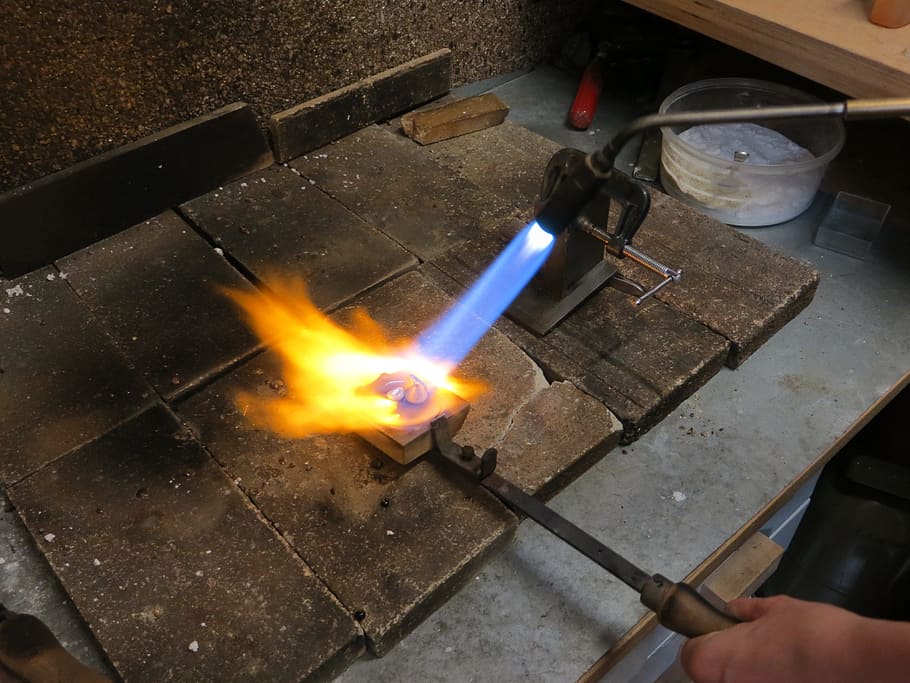 fire, silver, melt, silversmith, flame, hot, craft, craftsmen, burning, heat - temperature, fire - natural phenomenon, human hand, hand, real people, human body part, one person, preparation, glowing, nature, motion, holding, high angle view, unrecognizable person, blurred motion, long exposure, finger, preparing food, metal industry, 4K