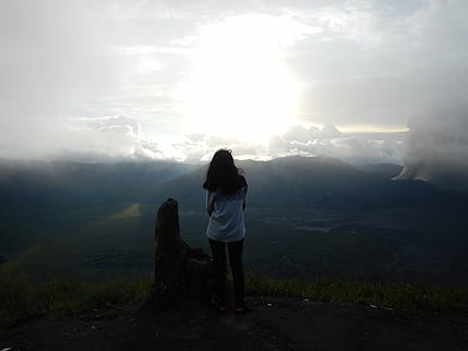 clouds, landscape, mountain range, mountains, nature, sky, sun, view, woman, one person, full length, rear view, real people, leisure activity, beauty in nature, scenics - nature, lifestyles, mountain, standing, non-urban scene, tranquility, women, adult, tranquil scene, casual clothing, outdoors, looking at view, 4K, CC0, public domain, royalty free