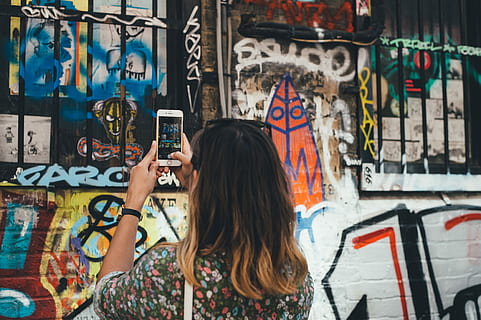 woman, black, floral, shirt, holding, silver iphone 6, taking, picture, graffiti, woman in black, silver, iPhone 6, people, women, paintings, one Person, urban Scene, only women, adult, street art, one woman only, creativity, art and craft, wall - building feature, real people, leisure activity, city, lifestyles, architecture, communication, waist up, hair, young adult, multi colored, casual clothing, hairstyle, outdoors, mural, 4K, CC0, public domain, royalty free
