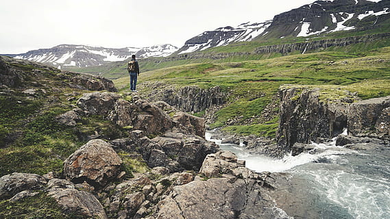 man, standing, rock, waterfalls, person, wearing, backpack, green, grass, rocky, ground, near, mountain, mountains, cliffs, valleys, fields, snow, rocks, water, stream, nature, outdoors, hike, trek, trail, hiker, backback, knapsack, one man only, one person, adults only, only men, adult, mature adult, people, rock - object, scenics - nature, leisure activity, beauty in nature, hiking, activity, adventure, travel, solid, full length, sky, vacations, landscape, mountain range, environment, 2K, CC0, public domain, royalty free