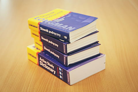 photo, four, dictionary, table, blue, yellow, longman, books, reading, study, school, learning, education, desk, stack, wood - material, close-up, no people, indoors, multi colored, day, book, text, publication, still life, focus on foreground, group of objects, communication, medium group of objects, expertise, western script, studio shot, finance, hardcover book, wood grain, 5K, CC0, public domain, royalty free