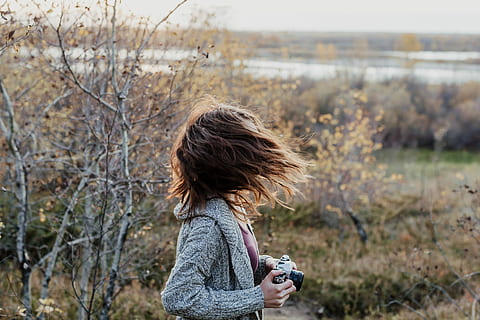 Foto, kvinde, vinke, hår, bedrift, kamera, selektiv, fokus fotografering, sort, græsfelt, portræt, efterår, vind, cardigan, træ, flod, flodbredden, pige, brunette, blad, film, en person, plante, fritidsaktivitet, natur, jord, fotografering temaer, frisure, barn, livsstil, dag, stående, rigtige mennesker, kamera - fotografisk udstyr, sidebillede, fokus på forgrunden, barndom, udendørs, 5K, CC0, offentligt domæne, royaltyfrie