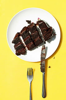 four, slice chocolate cakes, plate, beside, fork, knife, cake, white, ceramic, stainless, steel, bread, chocolate, food, desserts, sweets, food and drink, no people, yellow, yellow background, colored background, directly above, unhealthy eating, kitchen utensil, eating utensil, ready-to-eat, freshness, indoors, still life, dessert, sweet food, indulgence, meat, sweet, table, temptation, chocolate cake, 5K, CC0, public domain, royalty free
