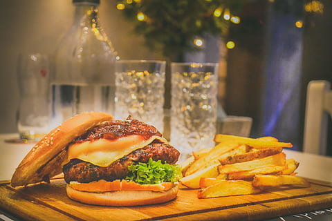 cooked foods, beef, bokeh, bottle, bread, buns, burger, calories, cheese, cheeseburger, close-up, dairy product, delicious, dish, drinking glasses, fast food, fat, food, french fries, fries, hamburger, lettuce, lights, liquid, meal, meat, photography, sandwich, tasty, tomatoes, vegetable, wooden planks, food and drink, ready-to-eat, unhealthy eating, freshness, focus on foreground, table, tomato, fruit, drink, red meat, bun, no people, glass, take out food, snack, ground beef, 4K, CC0, public domain, royalty free