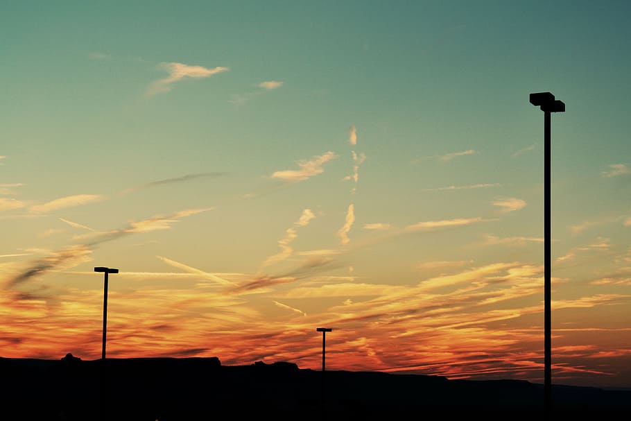 silhouette, light posts, post, cloudy, sky, sunset, lamp posts, dusk, clouds, street light, no people, cloud - sky, outdoors, nature, beauty in nature, scenics, street, orange color, scenics - nature, lighting equipment, low angle view, tranquil scene, tranquility, pole, floodlight, dramatic sky, idyllic, 4K