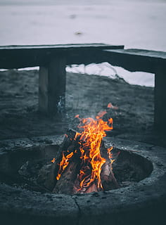 bonfire, bench, sea, daytime, photo, firewoods, burnt, inside, gray, firepit, sand, body, water, body of water, fire, campfire, burn, flame, fire - Natural Phenomenon, heat - Temperature, burning, nature, wood - Material, outdoors, red, no people, motion, land, smoke - physical structure, environment, orange color, beauty in nature, log, wood, power in nature, 2K, CC0, public domain, royalty free