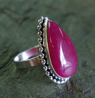 ruby, red, teardrop, silver, metal, jewelry, jewel, stone, gem, gemstone, huge, cabochon, cab, ring, setting, sterling, close-up, no people, necklace, still life, indoors, luxury, two objects, wealth, focus on foreground, personal accessory, high angle view, table, single object, fashion, pearl jewelry, precious gem, elegance, semi-precious gem, silver colored, ornate, 1080P, CC0, public domain, royalty free