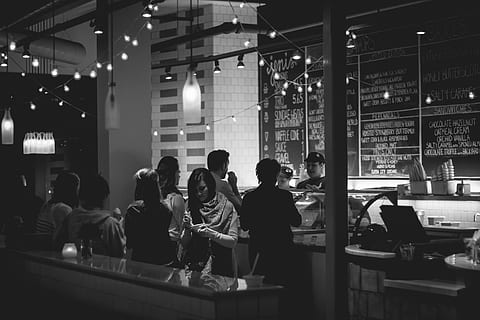 black-and-white, customers, dessert, ice cream parlor, people, group of people, real people, illuminated, men, indoors, night, women, adult, food and drink, restaurant, group, business, medium group of people, standing, lifestyles, table, lighting equipment, crowd, leisure activity, bar counter, bartender, nightlife, 4K