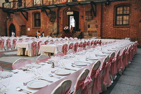 castle, Table, tableware, wedding, table set, pink, elegant, restaurant, chair, event, celebration, wedding Reception, dining, dinner, tablecloth, no People, banquet, day, architecture, indoors, building exterior, arrangement, seat, place setting, in a row, setting, business, empty, large group of objects, food and drink, plate, order, built structure, glass, absence, incidental people, setting the table, 5K, CC0, public domain, royalty free