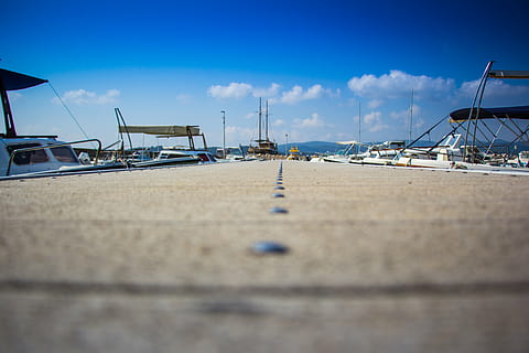 boats, clouds, dock, harbor, harbour, motorboats, perspective, sky, water, sea, transportation, nautical vessel, cloud - sky, mode of transportation, land, beach, nature, blue, day, sailboat, moored, no people, outdoors, pier, focus on background, marina, surface level, yacht, 4K
