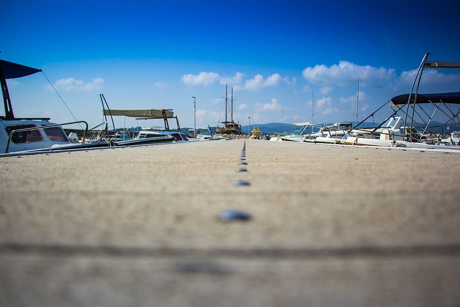 boats, clouds, dock, harbor, harbour, motorboats, perspective, sky, water, sea, transportation, nautical vessel, cloud - sky, mode of transportation, land, beach, nature, blue, day, sailboat, moored, no people, outdoors, pier, focus on background, marina, surface level, yacht, 4K