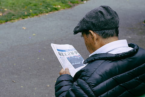 adult, bubble shell jacket, environment, jacket, leisure, man, newspaper, old, outdoors, reading, road, street, one person, men, day, one man only, close-up, people, real people, clothing, paper, holding, rear view, hat, city, focus on foreground, lifestyles, cap, casual clothing, 5K, CC0, public domain, royalty free