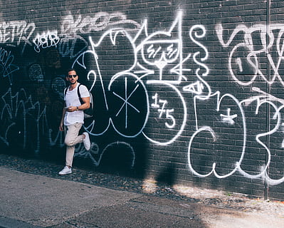 man, wearing, white, crew-neck t-shirt, leaning, black, wall, graffiti, graffiti wall, Cool as, cucumber, guy, male, people, young Adult, one Person, women, blackboard, females, full length, standing, creativity, art and craft, real people, wall - building feature, board, casual clothing, text, child, lifestyles, front view, chalk - art equipment, formula, chalk drawing, complexity, contemplation, 5K, CC0, public domain, royalty free