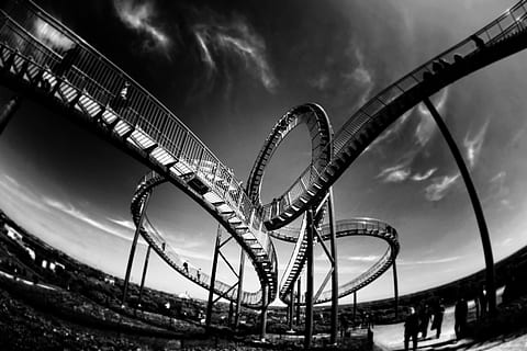 grayscale photo, bridge, rollercoaster, looping, amusement, coaster, park, ride, entertainment, speed, loop, excitement, leisure, rail, action, thrill, funfair, enjoyment, theme, height, joy, extreme, metal, attraction, curves, adrenaline, velocity, rush, steel, fun, arts culture and entertainment, cloud - sky, amusement park, amusement park ride, sky, nature, leisure activity, no people, curve, carnival, outdoors, low angle view, built structure, architecture, dusk, overcast, riding, 2K, CC0, public domain, royalty free