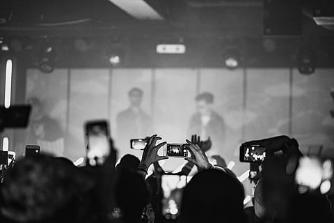 crowd, taking, photo, man, wearing, black, sunglasses, grayscale concert photo, grayscale, concert, people, black And White, group Of People, photography themes, adults only, focus on foreground, photographing, communication, real people, arts culture and entertainment, large group of people, technology, activity, smart phone, wireless technology, enjoyment, mobile phone, portable information device, indoors, music, event, photo messaging, filming, popular music concert, nightlife, digital camera, human arm, 4K, CC0, public domain, royalty free