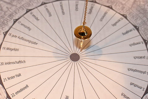 gold-colored pendant, wheel, Pendulum, Boards, Board, pendulum boards, template, vibrations, vibration, pendulum vibrations, commute, lot, cone, conical, tools, frequency, new age, spiritual, symbol, pendulum frequency, direction, east, no people, close-up, concentric, classical music, indoors, day, number, full frame, pattern, geometric shape, circle, paper, backgrounds, text, page, low angle view, arts culture and entertainment, shape, protection, still life, design, security, ceiling, directly below, 1080P, CC0, public domain, royalty free