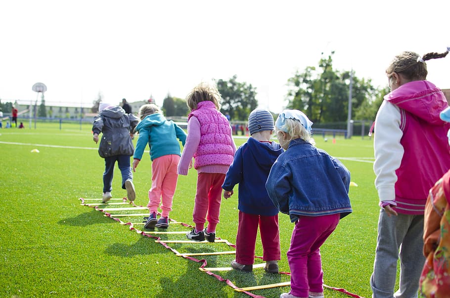 people, field, playing, grass, action, activity, boy, children, day, exercise, fun, girls, green, group, kids, little, motion, outdoors, sports, sunlight, training, young, group of people, real people, rear view, men, leisure activity, women, sport, lifestyles, medium group of people, nature, plant, full length, crowd, sky, casual clothing, warm clothing, 5K