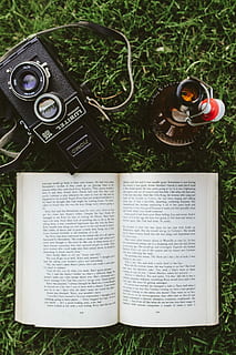 grass, Book, reading, leaf, literature, camera - Photographic Equipment, old-fashioned, old, music, high angle view, directly above, day, communication, technology, text, publication, plant, open, no people, close-up, nature, paper, arts culture and entertainment, page, retro styled, 2K, CC0, public domain, royalty free