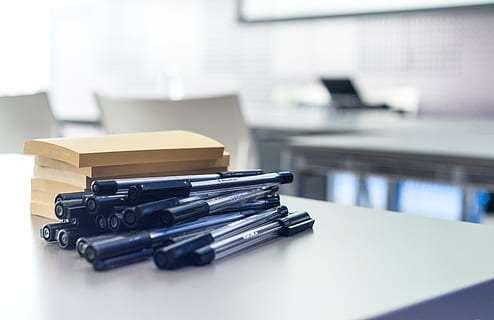black, ballpoint pen lot, white, table, workshop, pens, post-it note, sticky note, business, board, office, note, paper, desk, computer, meeting, event, workplace, work, classroom, chairs, no people, factory, indoors, manufacturing equipment, close-up, day, stack, furniture, focus on foreground, large group of objects, corporate business, selective focus, document, office supply, technology, still life, copy space, container, 5K, CC0, public domain, royalty free