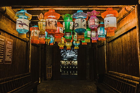 photo, assorted-color chinese lanterns, inside, room, lighted, lantern, ceiling, light, hanging, wooden, walls, fence, street, chinatown, china, culture, lighting, latern, town, warm, no people, architecture, lighting equipment, built structure, art and craft, text, large group of objects, building, indoors, religion, decoration, belief, day, multi colored, illuminated, 5K, CC0, public domain, royalty free