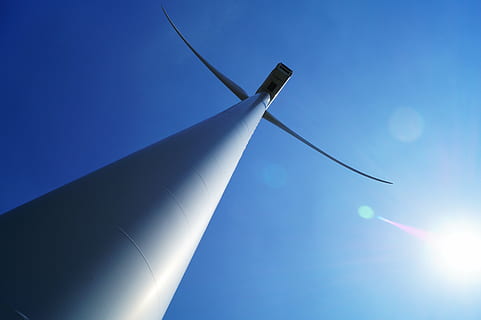 white, wind turbine, blue, sky, architecture, building, structure, tower, clouds, sun, flare, sunlight, no people, science, outdoors, day, refraction, close-up, lens flare, nature, clear sky, sunny, sport, low angle view, aircraft wing, airplane, accuracy, fuel and power generation, technology, industry, directly below, 5K, CC0, public domain, royalty free