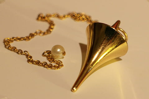 gold-colored pendant necklace, white, surface, pendulum, commute, lot, cone, conical, metal, metal piece, tool, tools, vibrations, frequency, vibration frequency, pendulum vibrations, pendulum frequency, new age, spiritual, rest, position, resting position, brass, gold, instrument, gloss, indoors, jewelry, still life, no people, close-up, wealth, studio shot, gold colored, luxury, table, necklace, paper, shiny, heart shape, creativity, high angle view, art and craft, single object, personal accessory, silver colored, 2K, CC0, public domain, royalty free